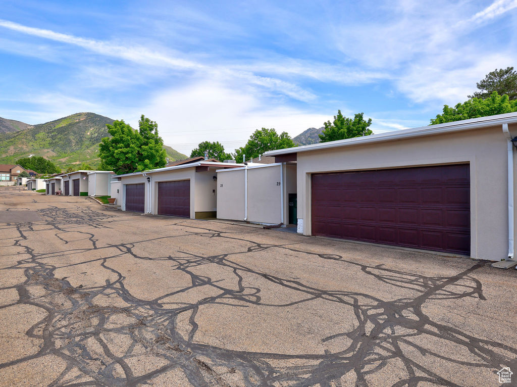 Single story home featuring a garage and a mountain view