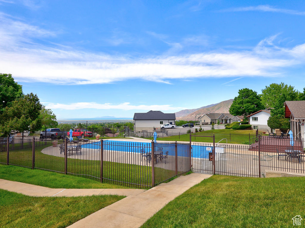 View of pool with a lawn