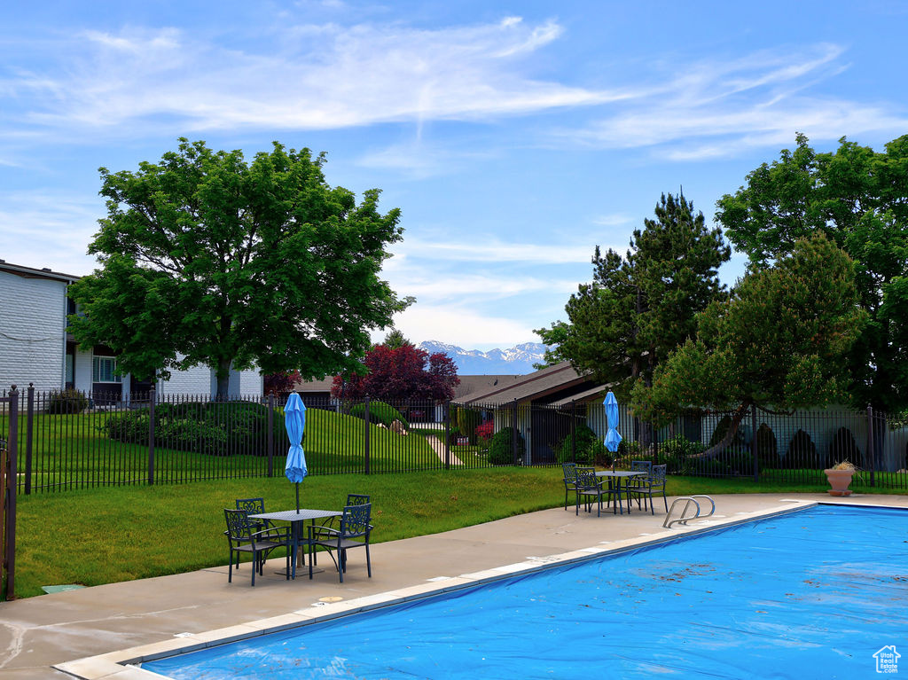 View of pool featuring a patio and a yard