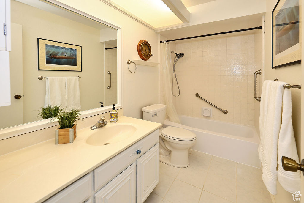 Full bathroom with tile flooring, vanity, toilet, and shower / bath combo