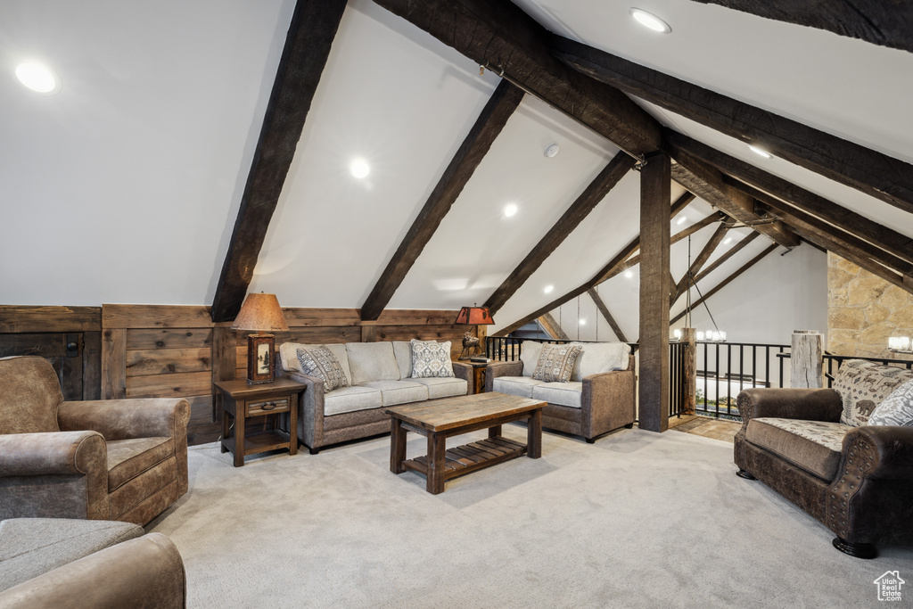 Living room with lofted ceiling with beams and carpet floors