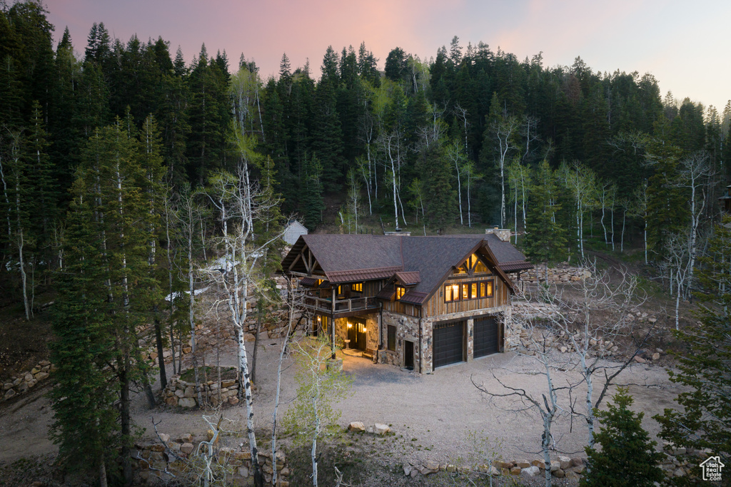 Back house at dusk with a garage