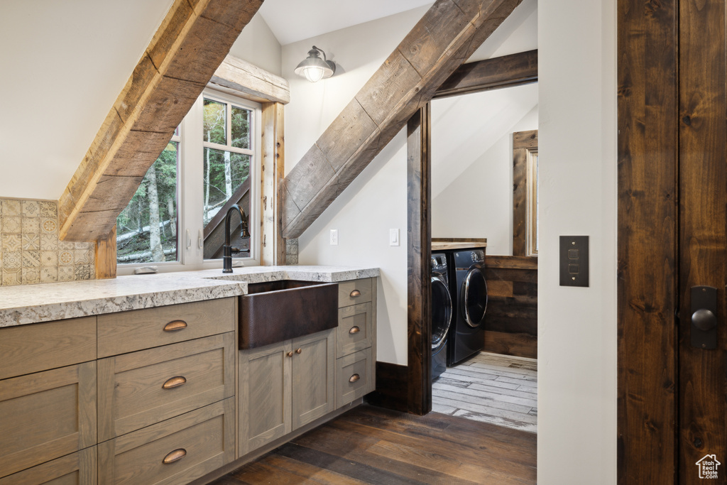 Bathroom with wood-type flooring, independent washer and dryer, vanity, and lofted ceiling