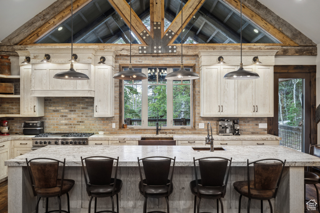 Kitchen featuring decorative light fixtures and tasteful backsplash