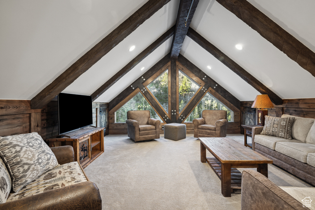 Living room featuring vaulted ceiling with beams and carpet