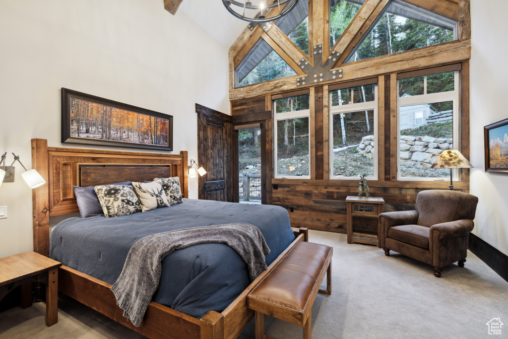 Bedroom featuring beamed ceiling, high vaulted ceiling, and carpet flooring