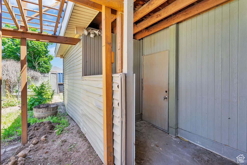 Doorway to property featuring a pergola