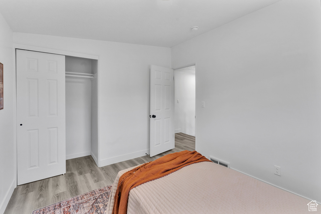 Bedroom featuring a closet and light hardwood / wood-style flooring