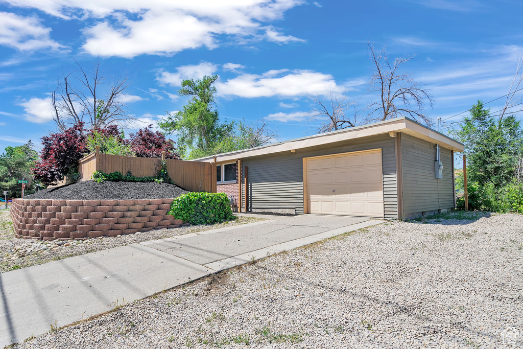 View of front of property featuring a garage and an outdoor structure