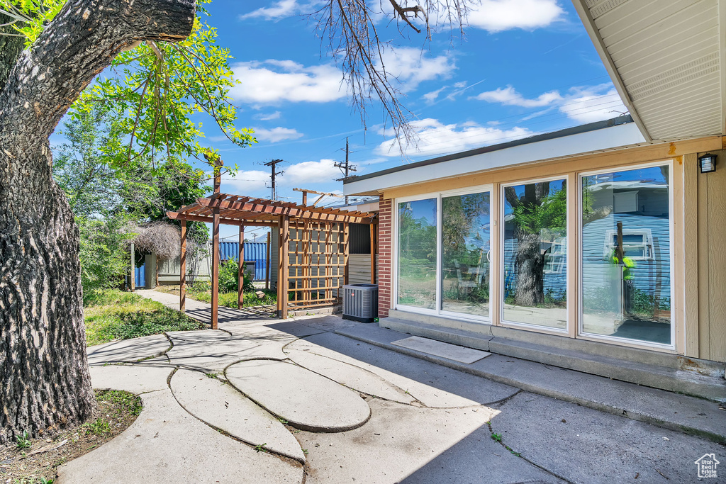 View of patio featuring a pergola and central air condition unit