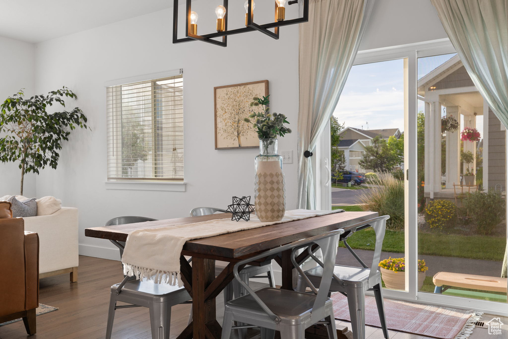 Dining area featuring an inviting chandelier and hardwood / wood-style floors