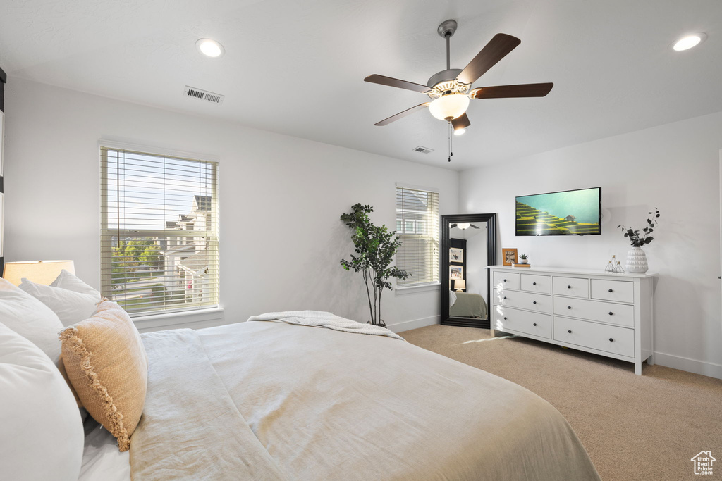 Bedroom featuring light carpet and ceiling fan