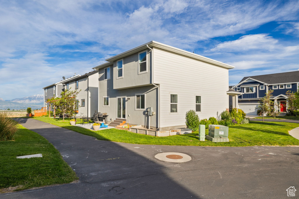 View of side of home featuring a lawn