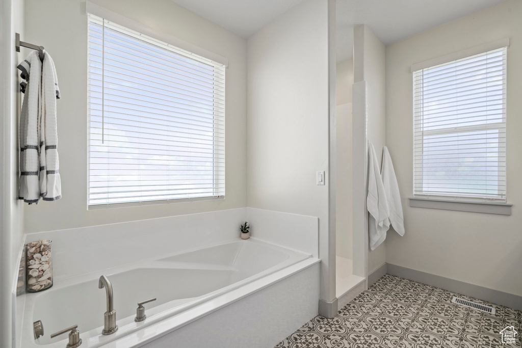 Bathroom with tile floors and a tub