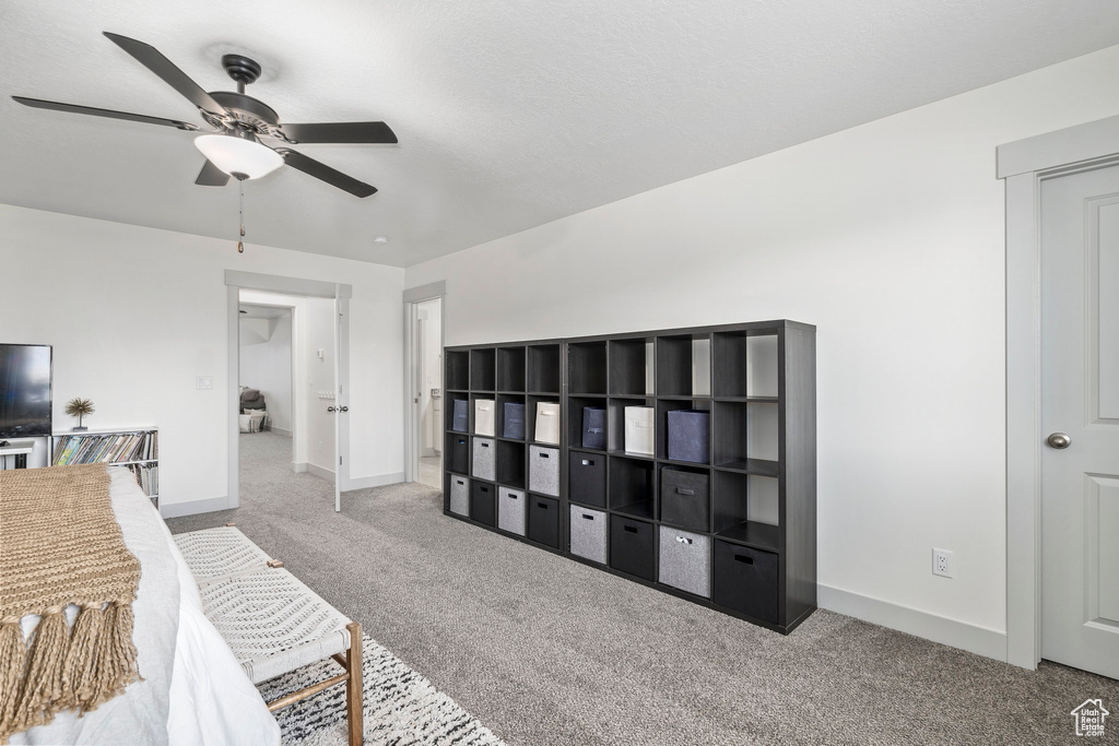 Carpeted bedroom with ceiling fan