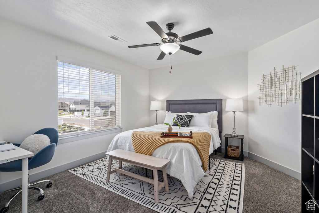 Carpeted bedroom with ceiling fan