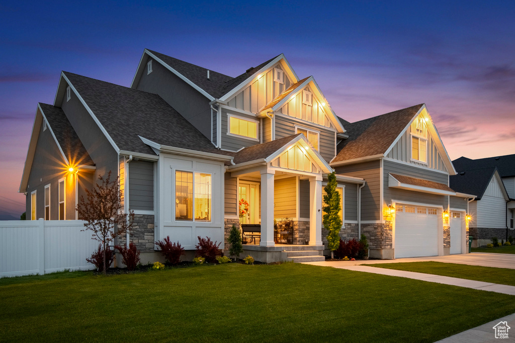 Craftsman-style house with a garage and a lawn