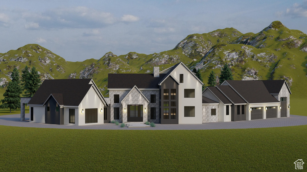 View of front of property featuring a front yard, a garage, and a mountain view