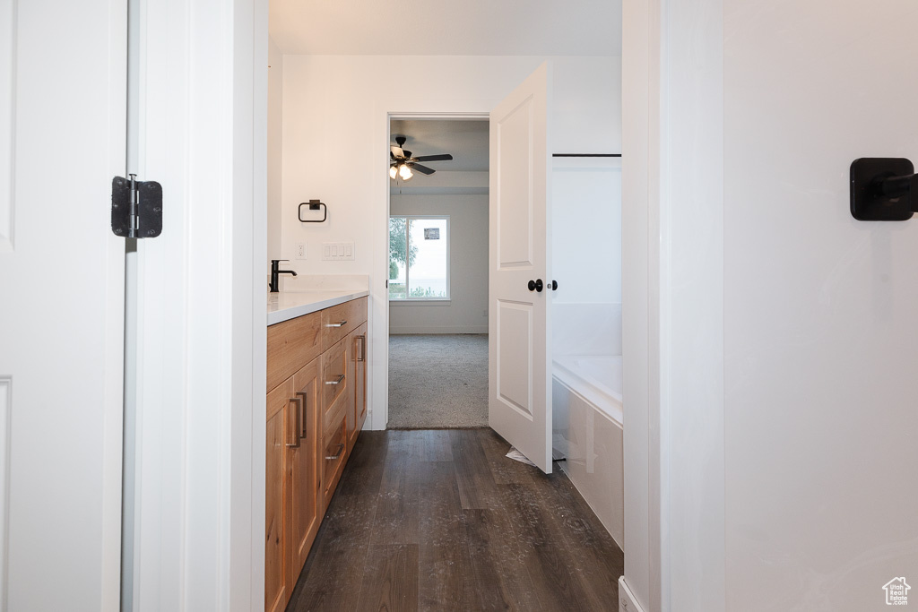 Bathroom featuring wood-type flooring, vanity, and ceiling fan