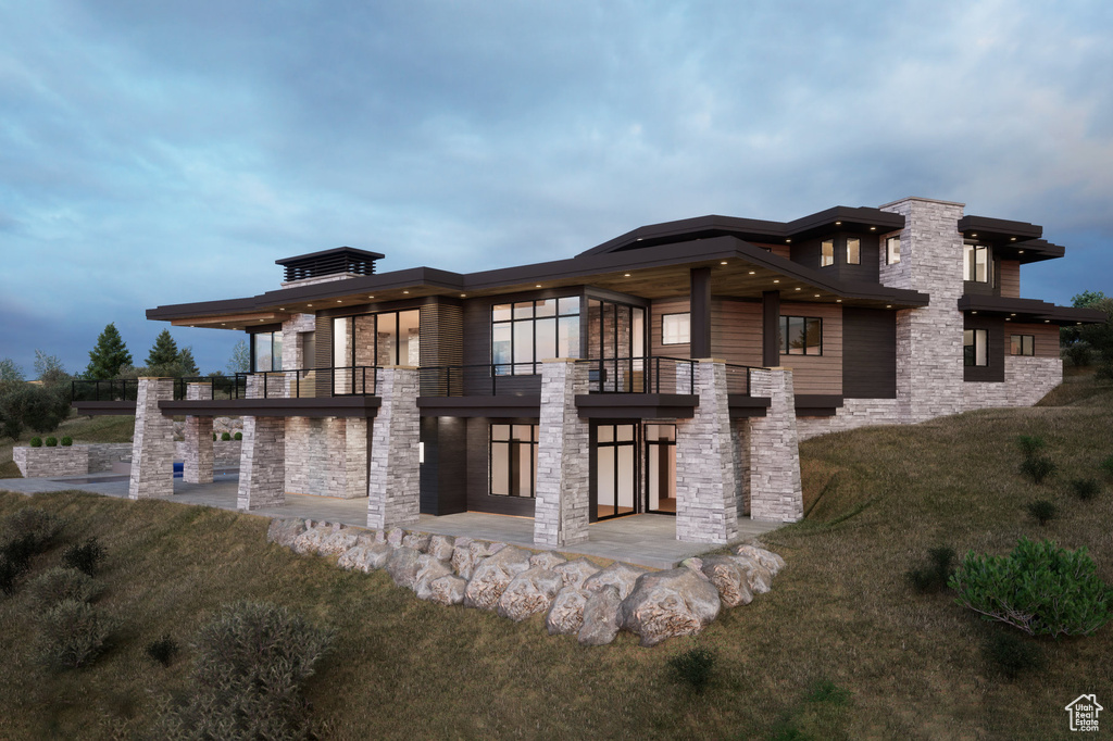 Back of house with a patio, a balcony, and a lawn