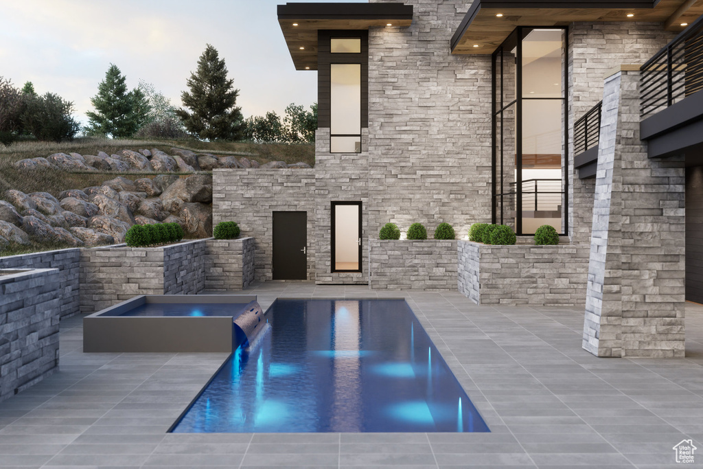 View of pool featuring a patio and an in ground hot tub