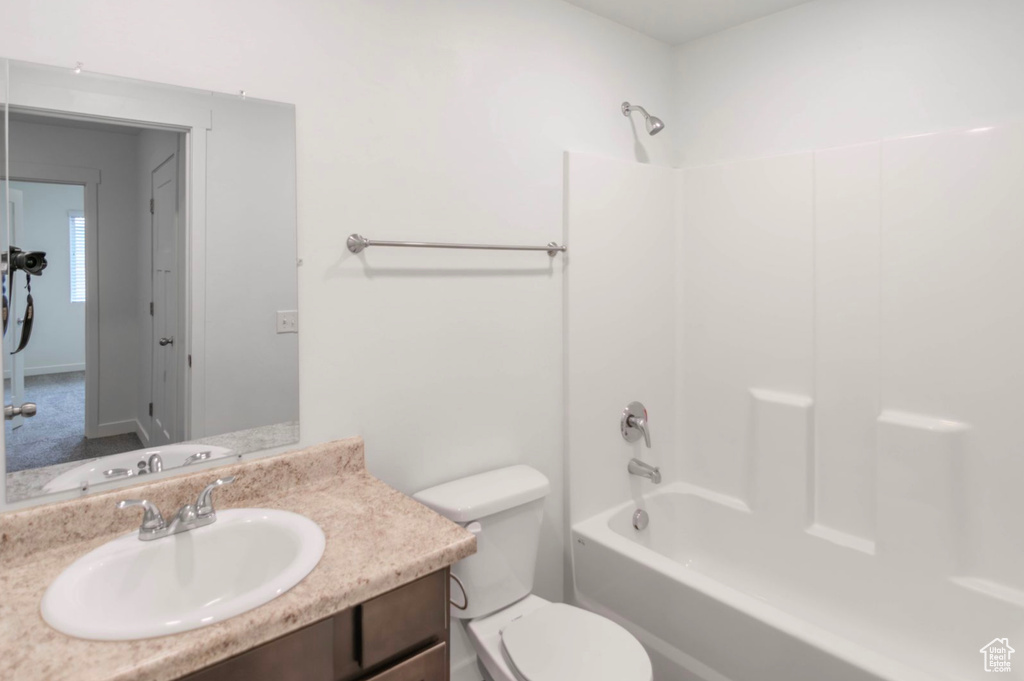 Full bathroom featuring bathtub / shower combination, toilet, and large vanity