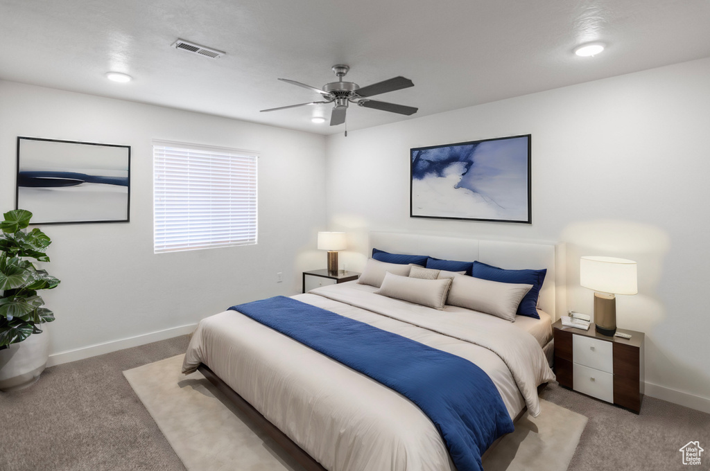 Carpeted bedroom with ceiling fan