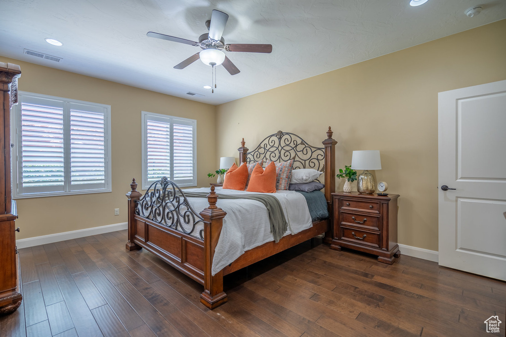 Bedroom with ceiling fan and dark wood-type flooring