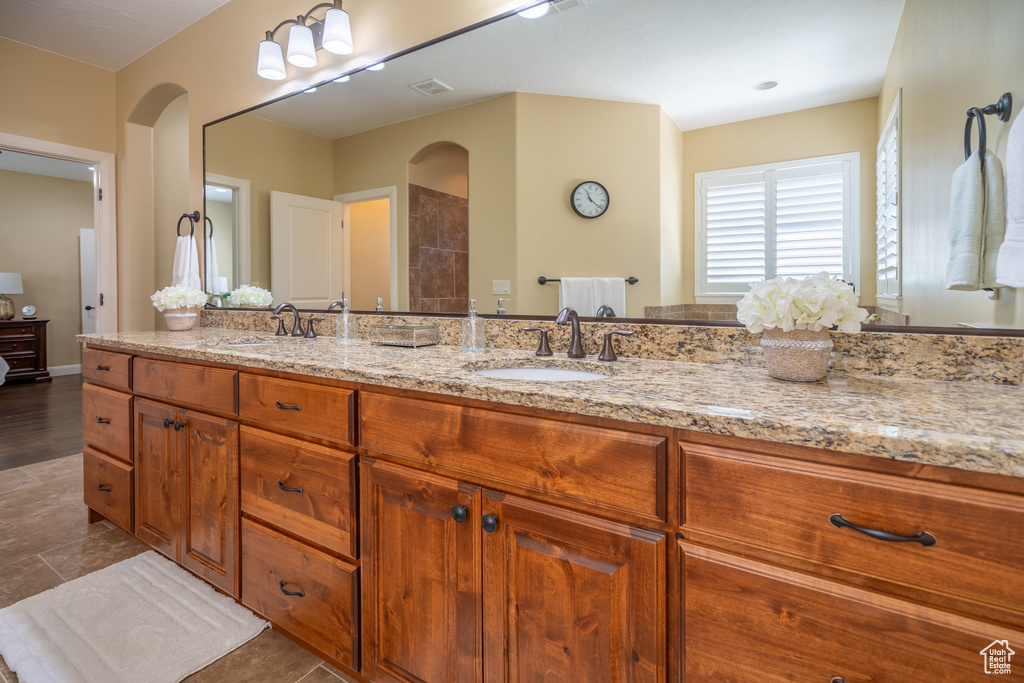 Bathroom featuring tile flooring and double sink vanity