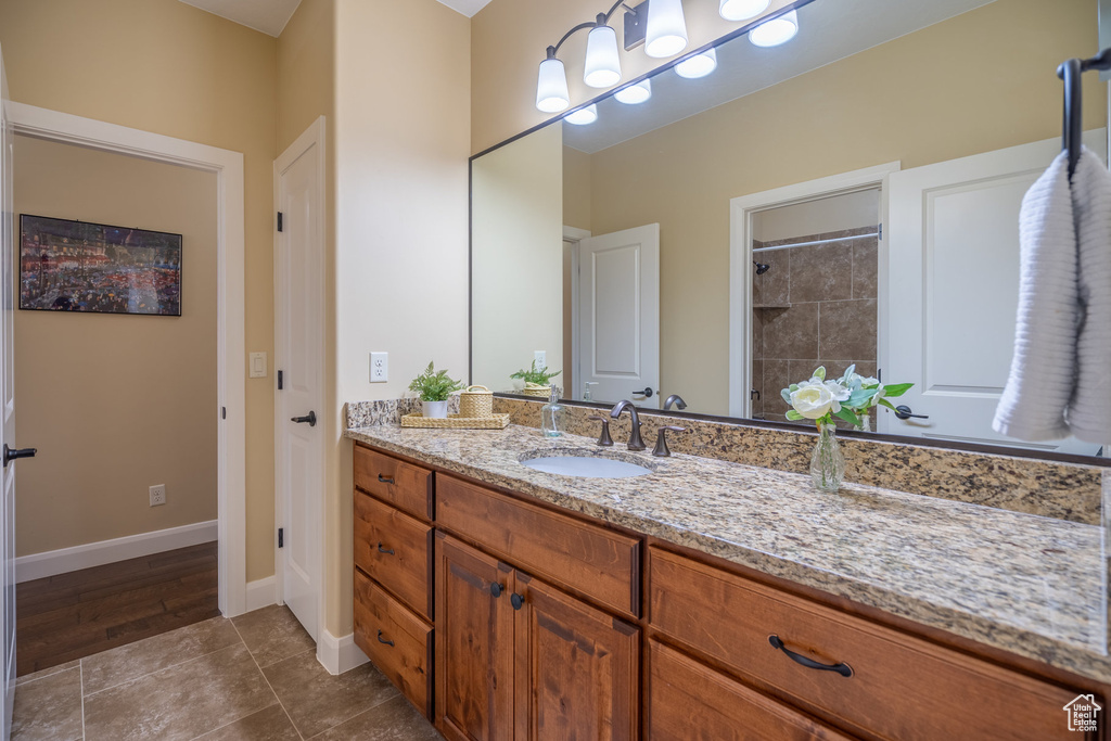 Bathroom with hardwood / wood-style flooring and large vanity