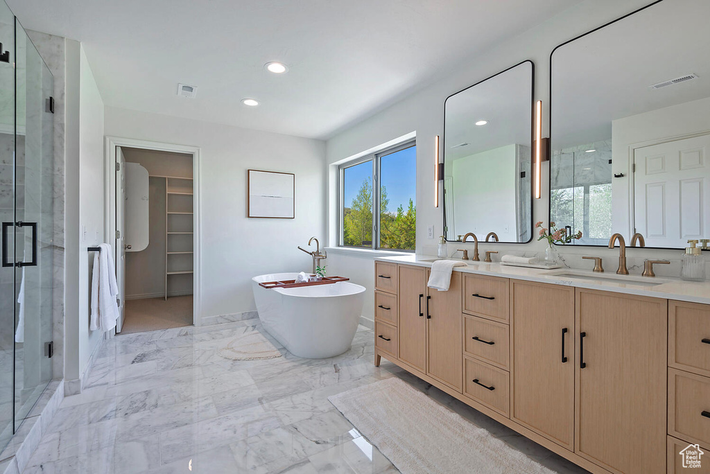 Bathroom featuring a healthy amount of sunlight, tile flooring, independent shower and bath, and vanity