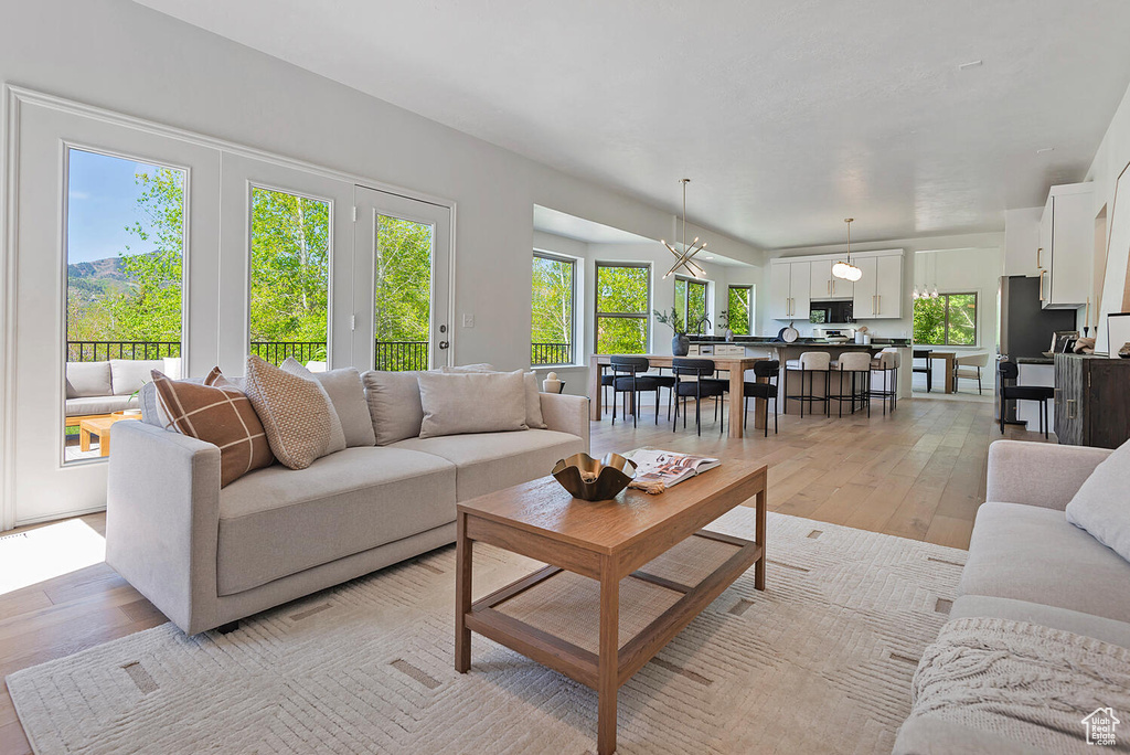 Living room featuring an inviting chandelier and light hardwood / wood-style floors