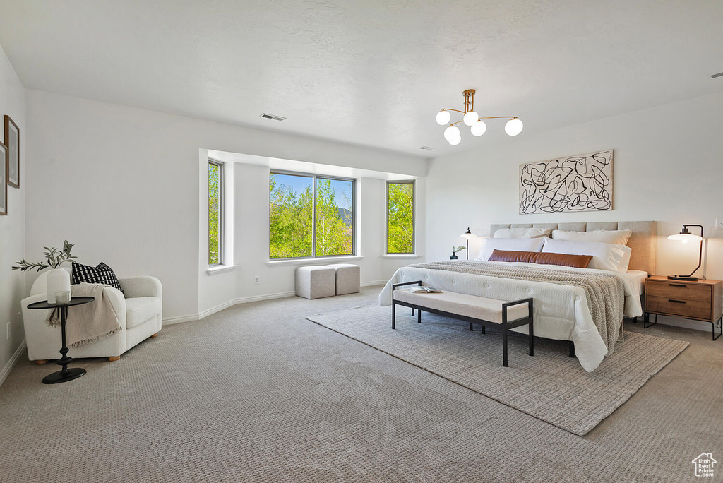 Bedroom with a chandelier and carpet floors