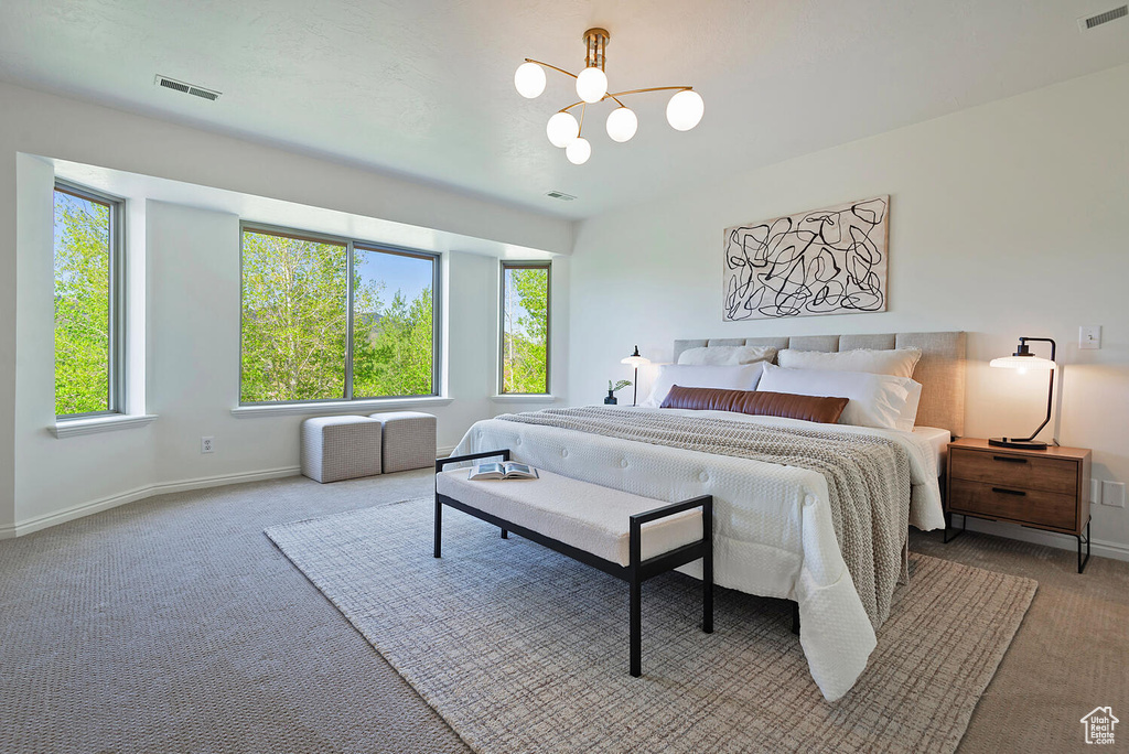 Bedroom with a notable chandelier and carpet