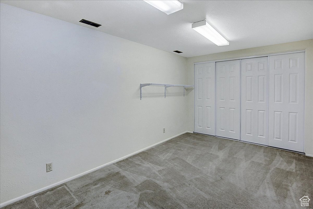 Unfurnished bedroom with a closet and carpet floors