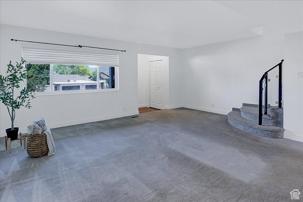 Unfurnished living room with dark colored carpet