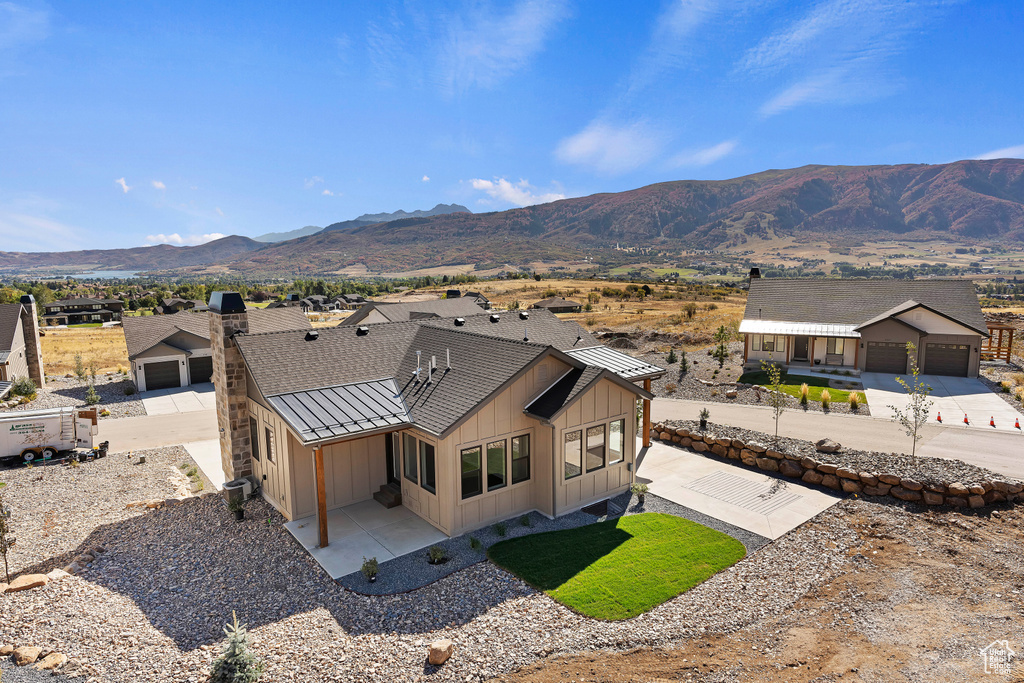 Exterior space with a mountain view and a garage