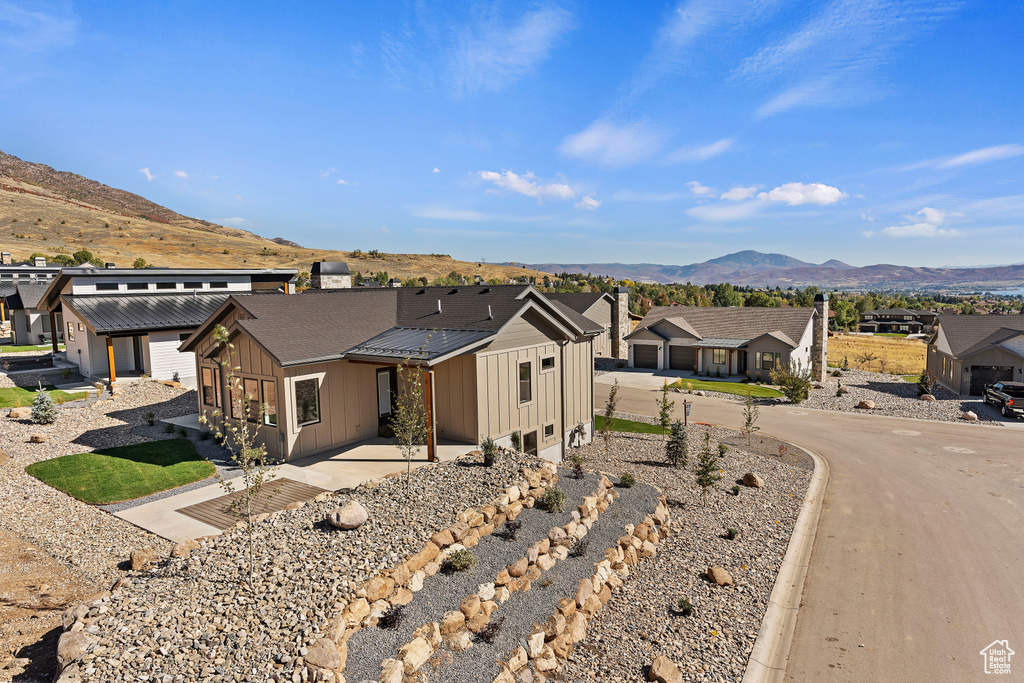 Ranch-style home with a patio and a mountain view