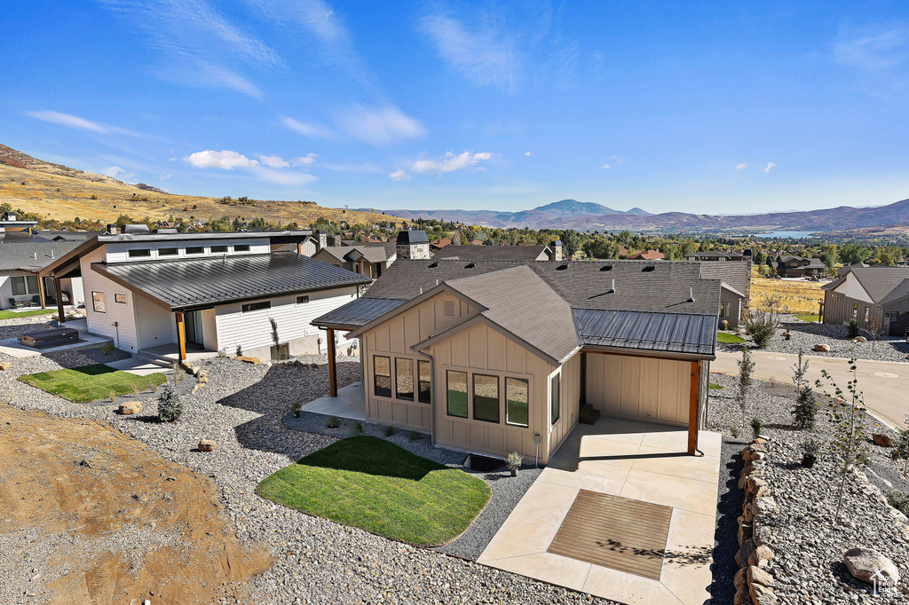 View of front facade with a garage and a mountain view