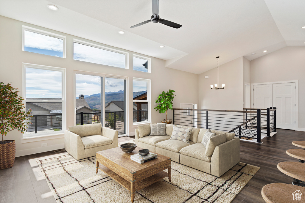 Living room featuring ceiling fan with notable chandelier, a mountain view, high vaulted ceiling, and dark hardwood / wood-style floors