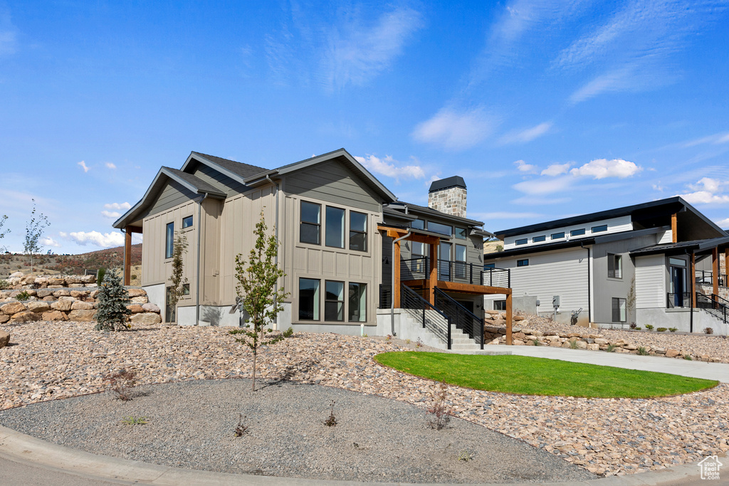 View of front of property with a wooden deck