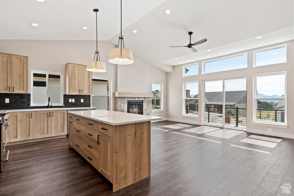 Kitchen with ceiling fan, a mountain view, hanging light fixtures, dark hardwood / wood-style floors, and decorative backsplash