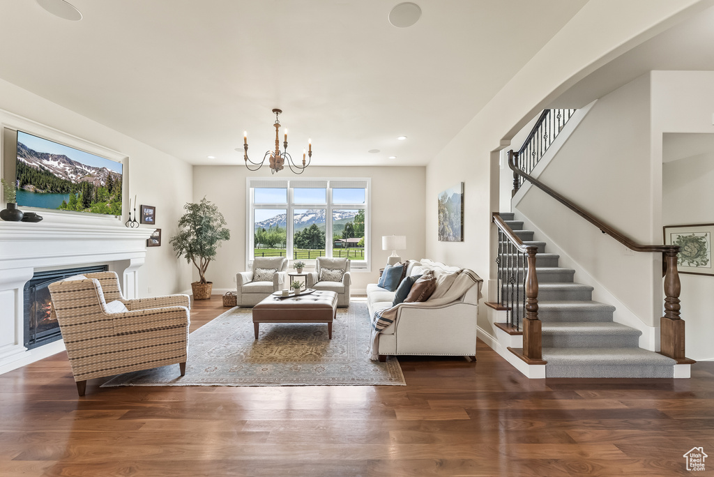 Living room featuring an inviting chandelier and dark hardwood / wood-style flooring