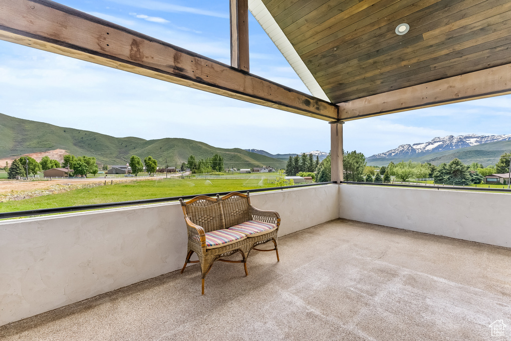 Exterior space with a mountain view and vaulted ceiling