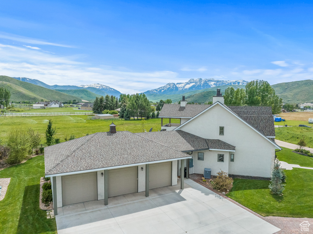 Exterior space with a front lawn and a mountain view