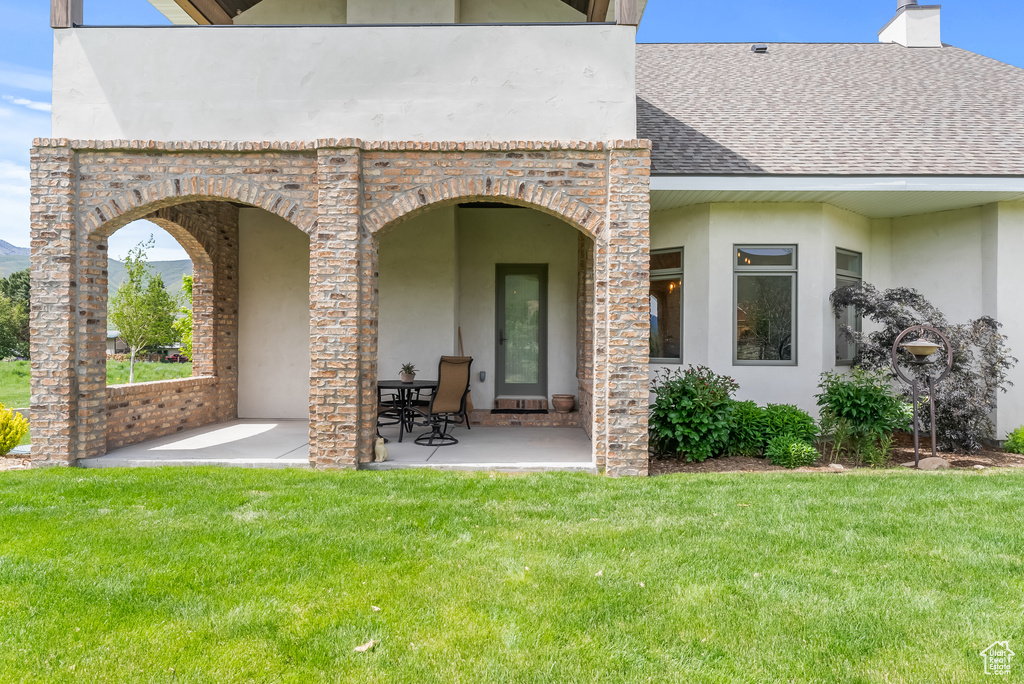 Rear view of property featuring a lawn