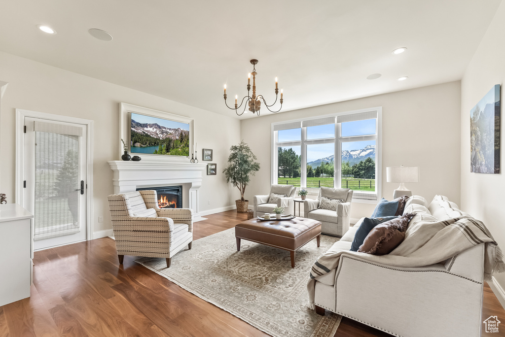 Living room featuring hardwood / wood-style flooring and a chandelier