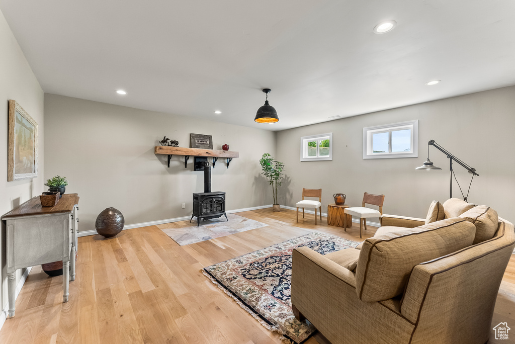 Living room with hardwood / wood-style floors and a wood stove