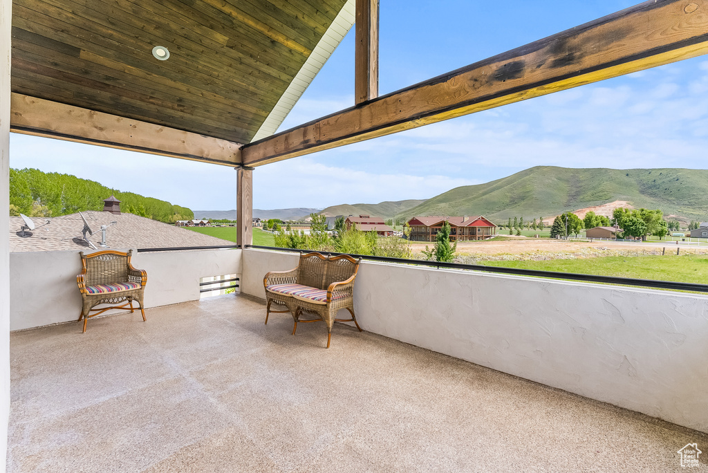 View of patio featuring a mountain view and a balcony