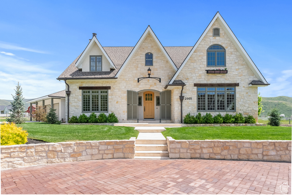 French country style house with a front yard